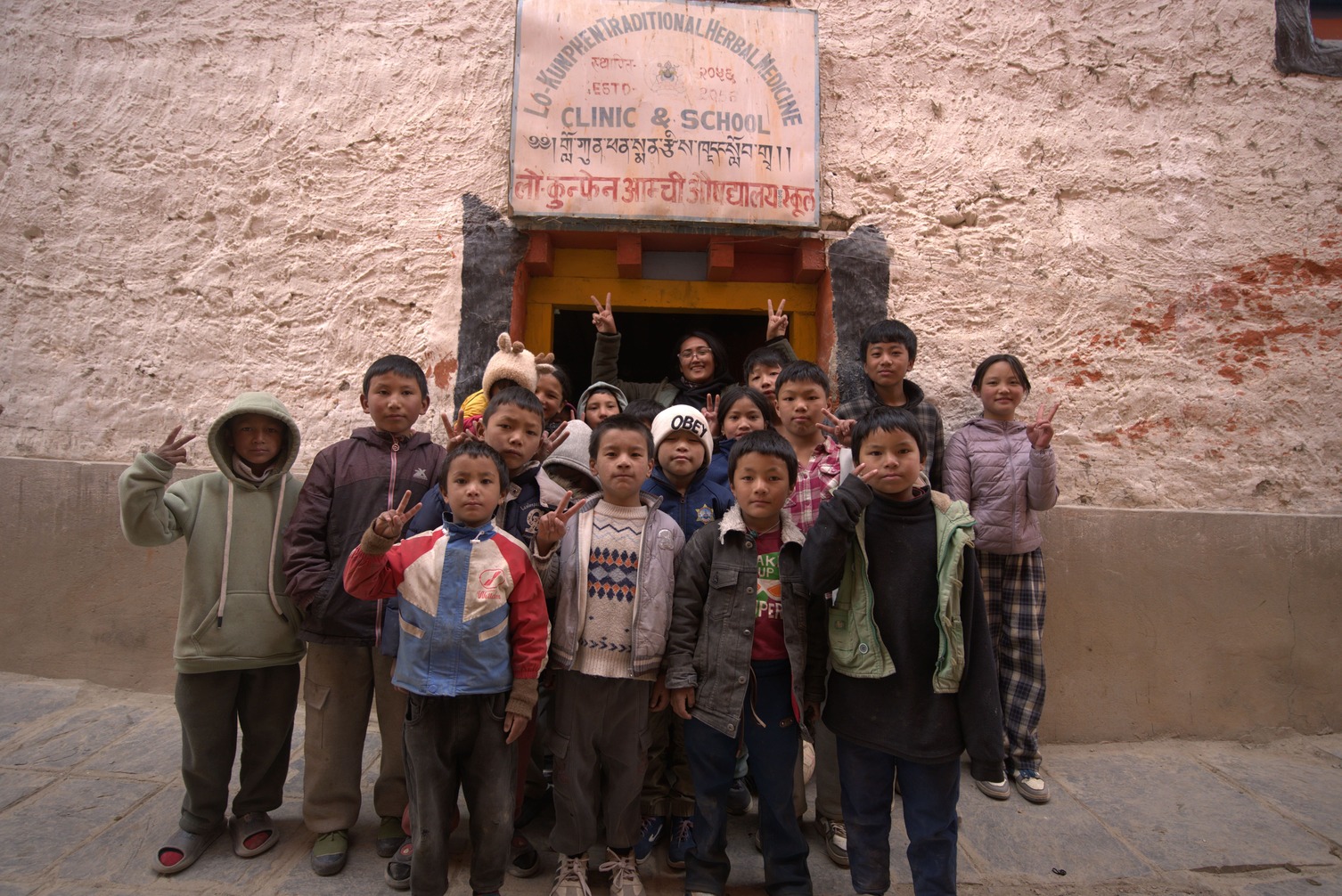202605240707_Nepal moto tours Road captain with Group of kids posing in Lomanthang.jpg